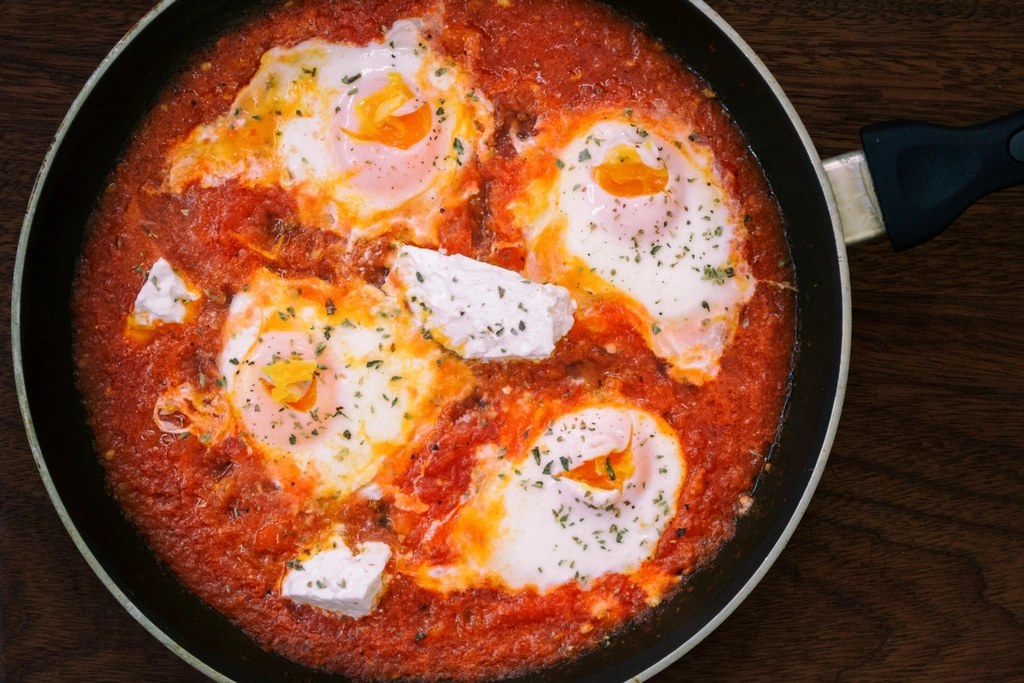 Eggs baked in spiced tomato sauce with crumbled feta